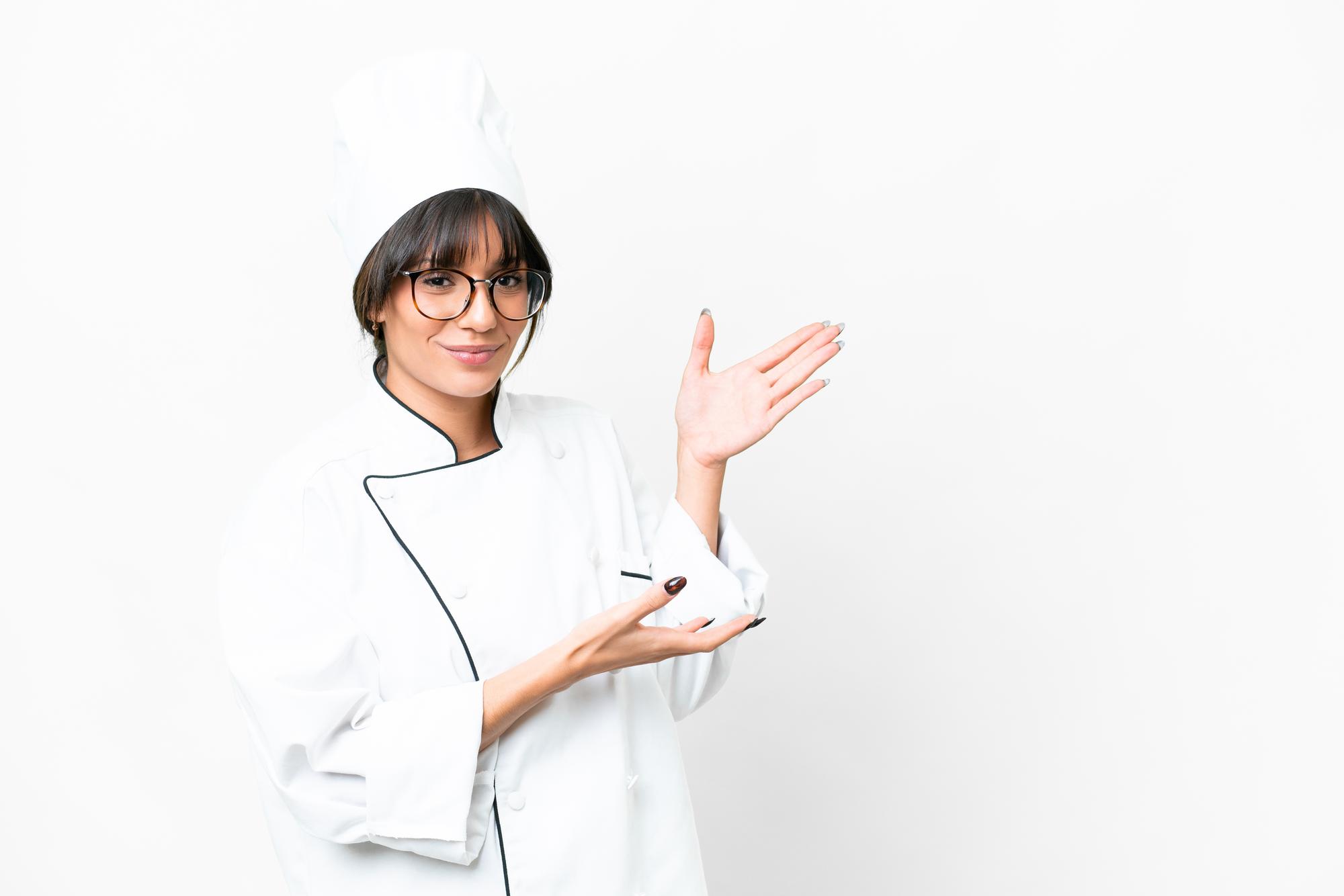 Chef welcoming workshop participants in a bright kitchen