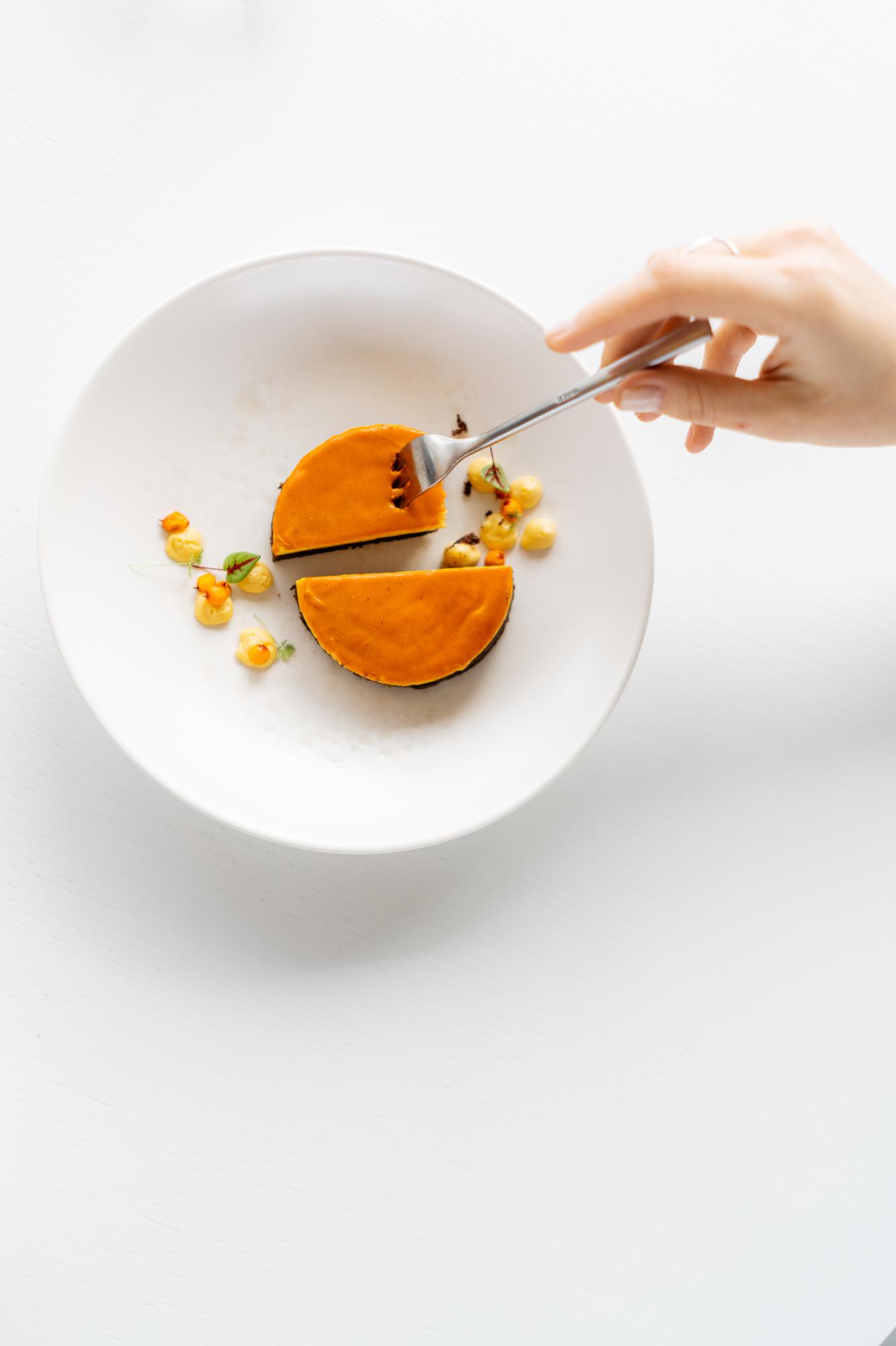 Close-up of a chef arranging a composed plate in calm light